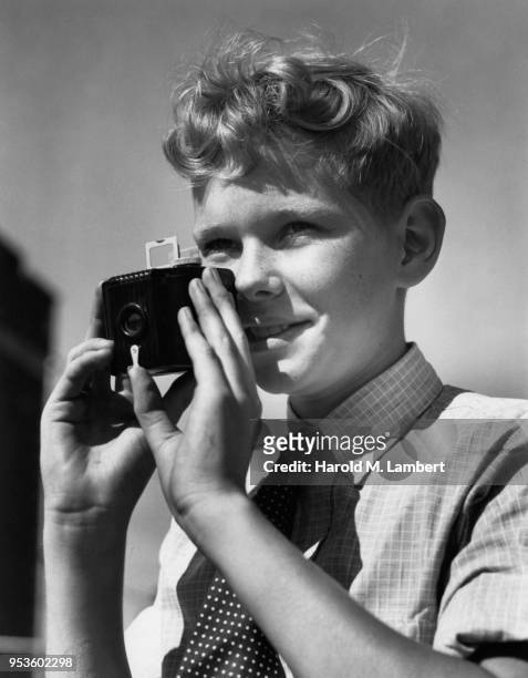 BOY TAKING PICTURES WITH CAMERA