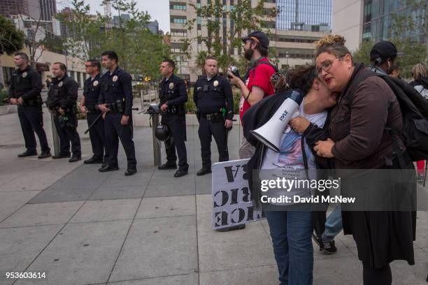 Valerie Rivera is hugged as she calls for justice for her son Eric, who was shot to death by police while holding a toy gun in a shooting that police...