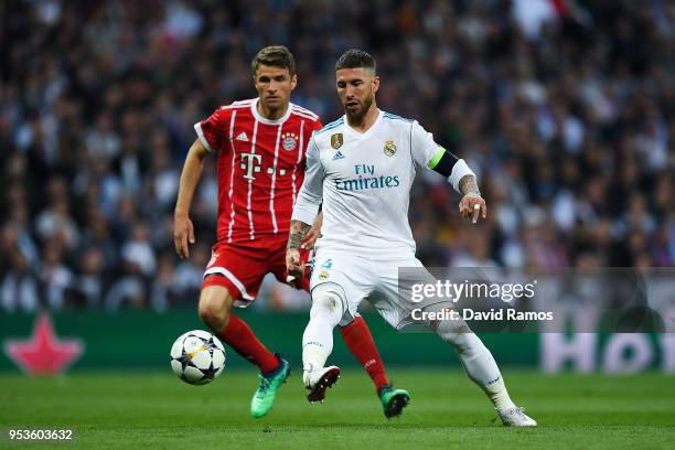 Sergio Ramos of Real Madrid CF competes for the ball with Thomas Muller of FC Bayern Muenchen during the UEFA Champions League Semi Final Second Leg...