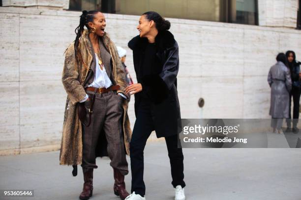 Models Adesuwa Aighewi, Binx Walton share a laugh after the Michael Kors show at Lincoln Center on February 14, 2018 in New York City. Adesuwa wears...