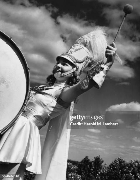 CLOSE-UP OF GIRL PLAYING DRUM IN MARCHING BAND