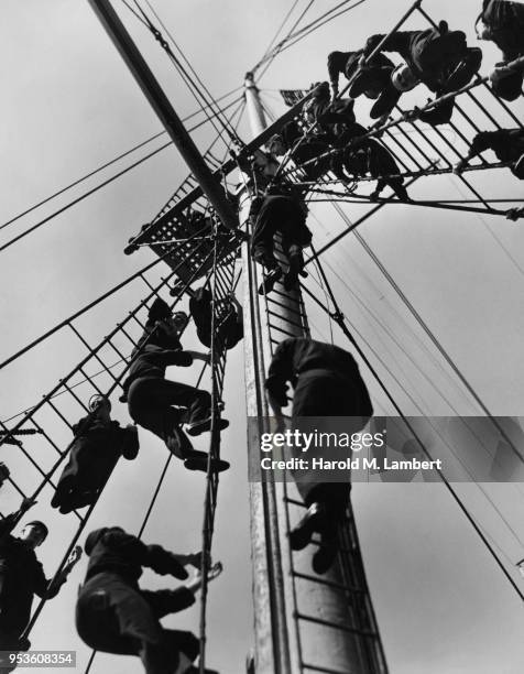 SAILORS CLIMBING UP SHIPS MAST