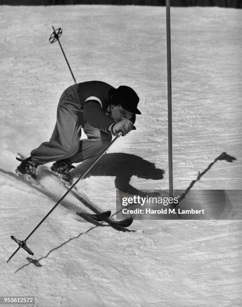 MID ADULT MAN SLALOM SKIING ON SNOW