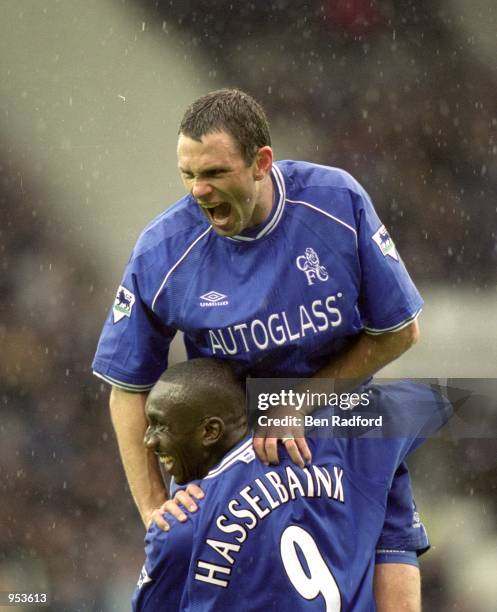 Gustavo Poyet celebrates with Jimmy Floyd Hasselbaink both of Chelsea during the FA Carling Premiership match against Derby County at Pride Park in...