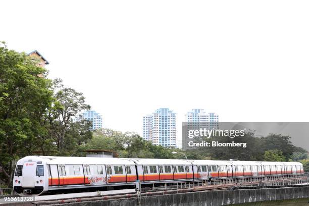 Mass Rapid Transit train, operated by SMRT Corp., travels on an elevated track in Singapore, on Thursday, April 26, 2018. Southeast Asian leaders...