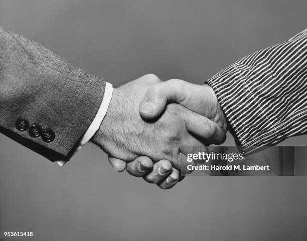 CLOSE-UP OF PEOPLE SHAKING HANDS