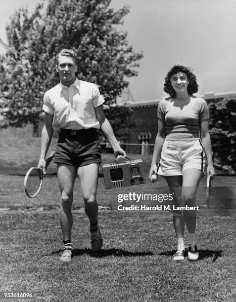 YOUNG COUPLE PLAYING TENNIS