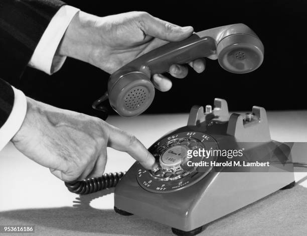HUMAN HAND DIALING NUMBER ON TELEPHONE