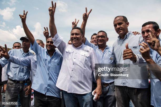 Evangelical pastor Javier Bertucci, presidential candidate for the Esperanza Por El Cambio Party, center, poses for a photograph with supporters...