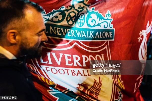 Supporter of United Kingdom's Liverpool team dances with the team's flag out of a pub in Campo de' Fiori Square in Rome, Italy, the night before UEFA...