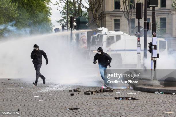 About 1200 masked and hooded protesters dressed in black attacked the police on May Day in Paris. Protesters smashed windows of businesses, torched...