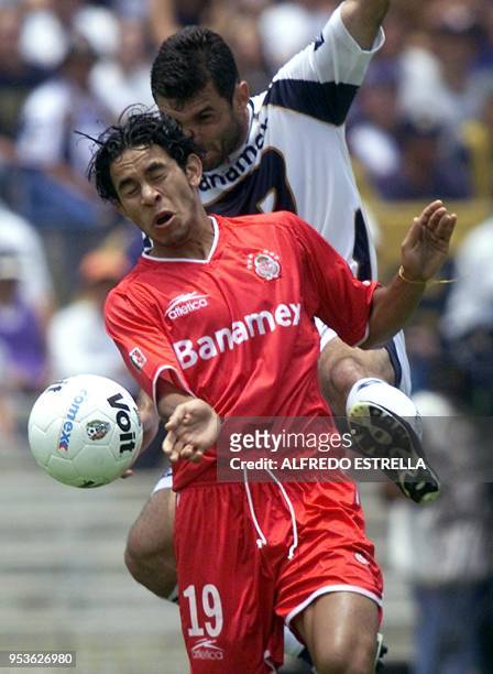 Soccer players Martin Garcia and Sergio Ponce are seen in action 25 August 2002. Martin Garcia de los Pumas de la UNAM, patea el balon sobre Sergio...