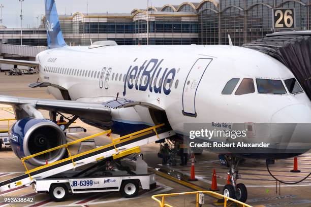 JetBlue Airways Airbus A320 jet is serviced at a gate at Ronald Reagan Washington National Airport in Washington, D.C.