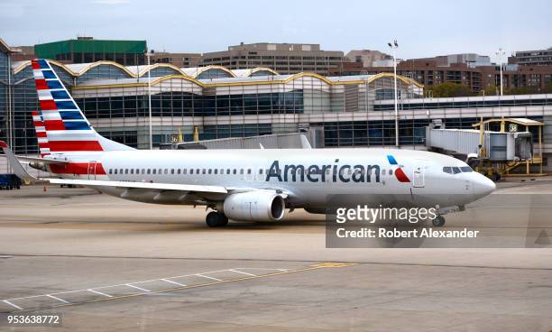 An American Airlines Boeing 737 passenger plane taxis from a gate to the runway at Ronald Reagan Washington National Airport in Washington, D.C.
