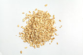 Oatmeal raw grains isolated on white background, top view.