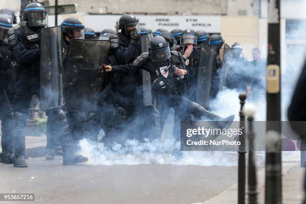 Anti-riot policemen in front of protestors during a demonstration on the sidelines of a march for the annual May Day workers' rally in Paris on May...