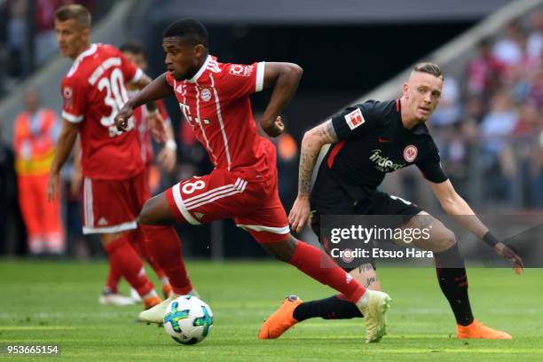 Franck Evina of Bayern Muenchen and Marius Wolf of Eintracht Frankfurt compete for the ball during the Bundesliga match between FC Bayern Muenchen...