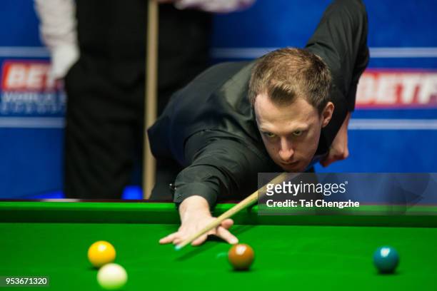 Judd Trump of England plays a shot in the quarter-final match against John Higgins of Scotland during day eleven of the World Snooker Championship at...