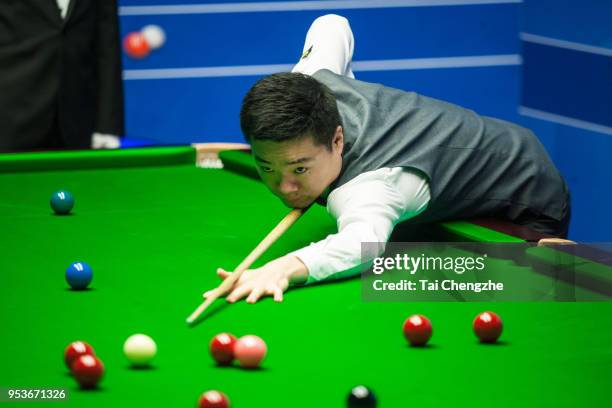 Ding Junhui of China plays a shot in the quarter-final match against Barry Hawkins of England during day eleven of the World Snooker Championship at...