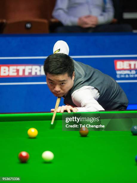 Ding Junhui of China plays a shot in the quarter-final match against Barry Hawkins of England during day eleven of the World Snooker Championship at...