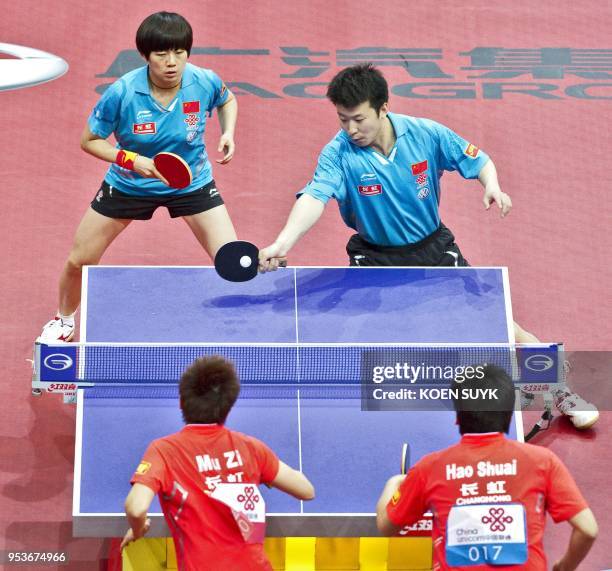 China's Zhang Chao and Cao Zhen return against China's Hao Shuai and Mu Zi during their mixed doubles final match at the World Tennis table...