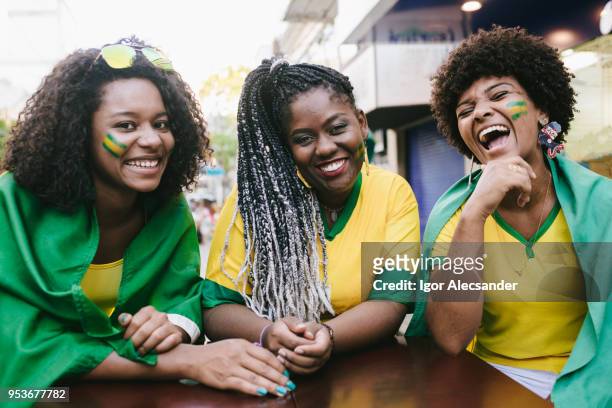 portrait of three brazilian friends - moving down to seated position stock pictures, royalty-free photos & images