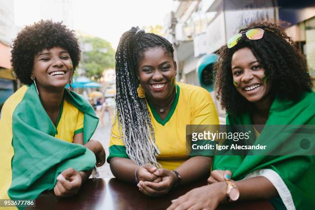 portrait of three brazilian friends - moving down to seated position stock pictures, royalty-free photos & images