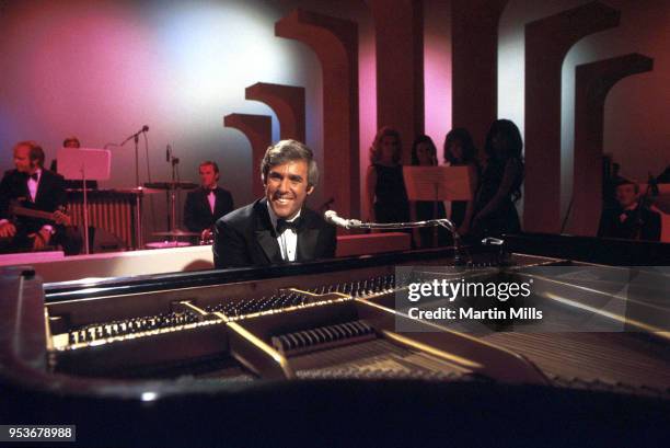 American composer, songwriter, singer and pianist Burt Bacharach performs on his piano circa 1968 in Los Angeles, California.