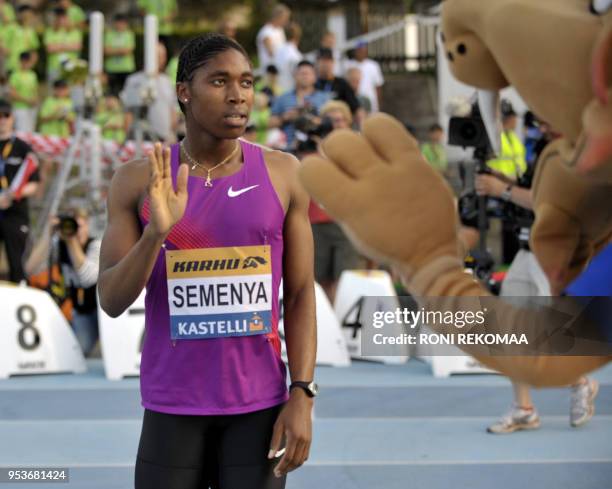 South African athlete Caster Semenya waves as she competes in the women's 800m race in Lappeenranta, Eastern Finland on July 15, 2010 for her first...