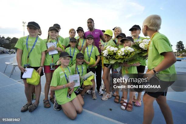 South African athlete Caster Semenya poses with fans in Lappeenranta, Eastern Finland on July 15, 2010 for her first start since the Berlin World...