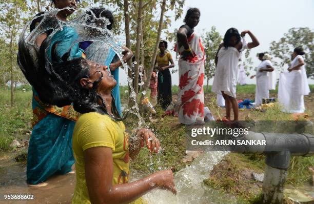 An Indian transgender devotee bathes after a ritual signifying their marriage to the Hindu warrior god Aravan at the Koothandavar Temple in the...