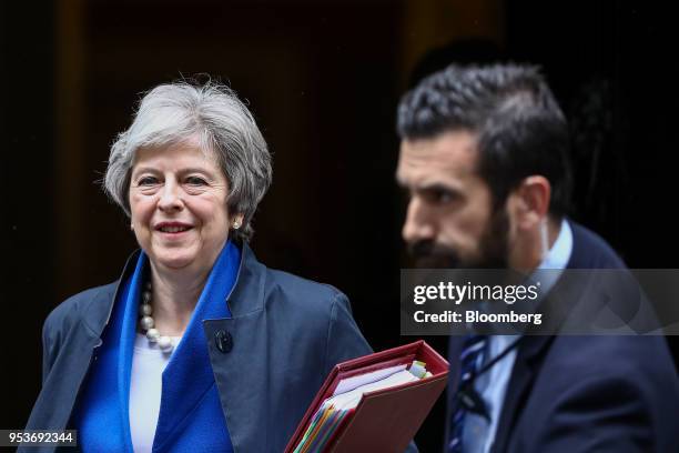 Theresa May, U.K. Prime minister, left, departs number 10 Downing Street to attend a weekly questions and answers session in Parliament in London,...