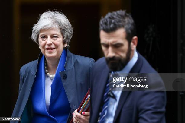 Theresa May, U.K. Prime minister, left, departs number 10 Downing Street to attend a weekly questions and answers session in Parliament in London,...