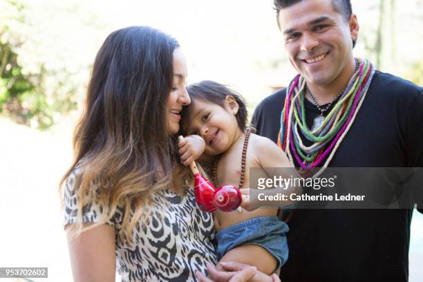 young family holding smiling toddler in summertime - catherine ledner foto e immagini stock