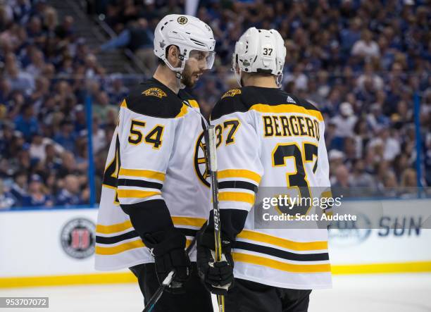 Patrice Bergeron and Adam McQuaid of the Boston Bruins against the Tampa Bay Lightning during Game Two of the Eastern Conference Second Round during...