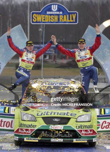 Finnish driver Jari-Matti Latvala and co-driver Miikka Anttila stand atop their Ford Focus RS after they won the 2008 Swedish Rally in Karlstad, 10...