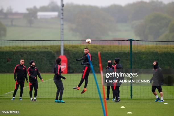 Arsenal's defender Calum Chambers jumps to head the ball takes part in a training session at the club's complex in London Colney on May 2, 2018 on...