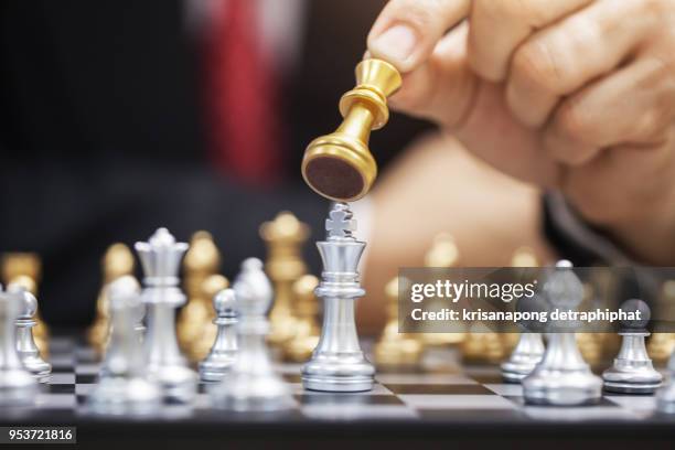 hand of businessman playing chess.,business concept, - chess king piece stock pictures, royalty-free photos & images