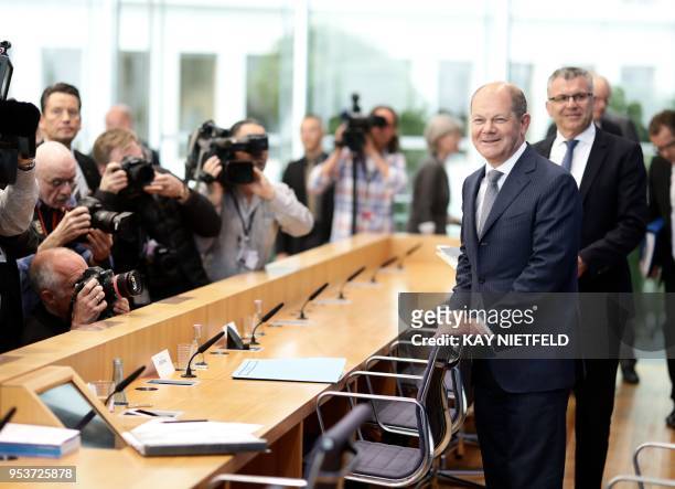 German Finance Minister Olaf Scholz arrives with the State Secretary at the Federal Ministry of Finance, Werner Gatzer at a press conference on the...