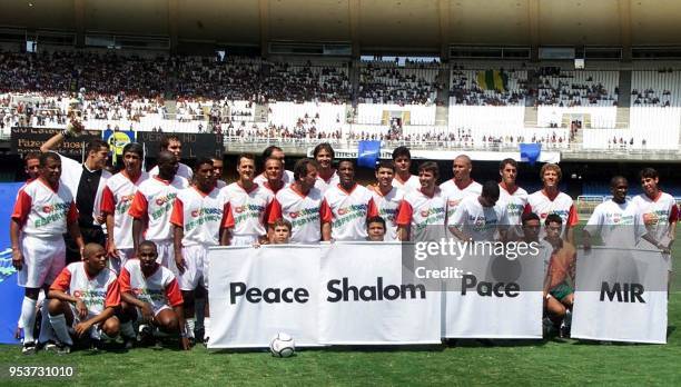 Children form the word Peace in various languages in front of F1 racing pilot Michael Schumacher of Germany , Jarno Trulli and Giancarlo Fisichella,...