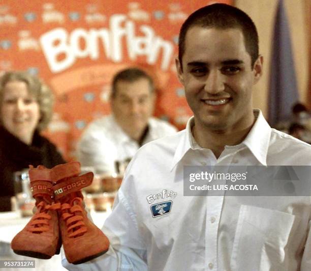 Juan Pablo Montoya Formula 1 pilot of the Williams stable, shows 24 March 2001 the pair of boots he wore, in Bogota, Colombia, he will auction them...