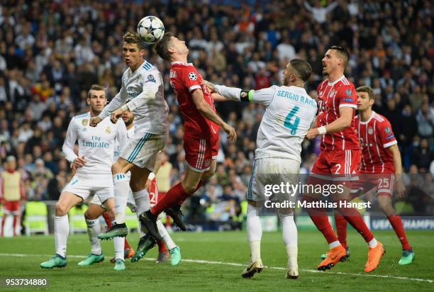 Cristiano Ronaldo of Real Madrid jumps for a header with Robert Lewandowski of FC Bayern Muenchen during the UEFA Champions League Semi Final Second...