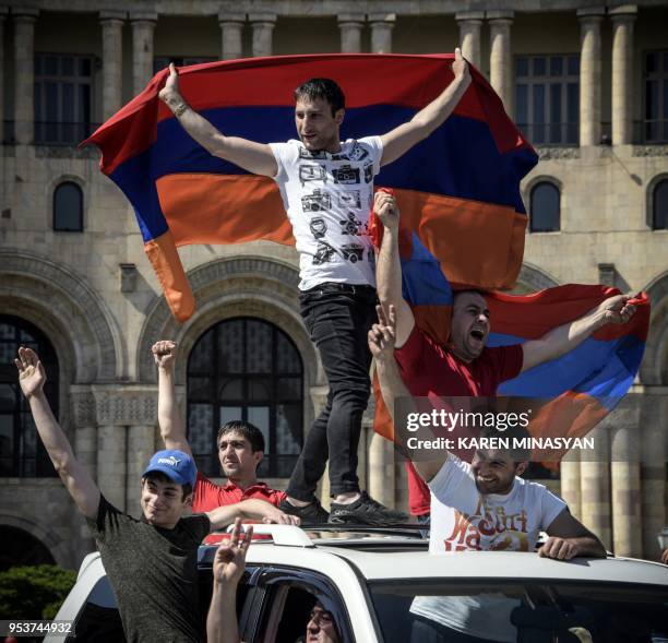 People hold an Armenian flag as they demonstrate in Yerevan on May 2 as popular anger exploded over the ruling party's rejection of opposition...