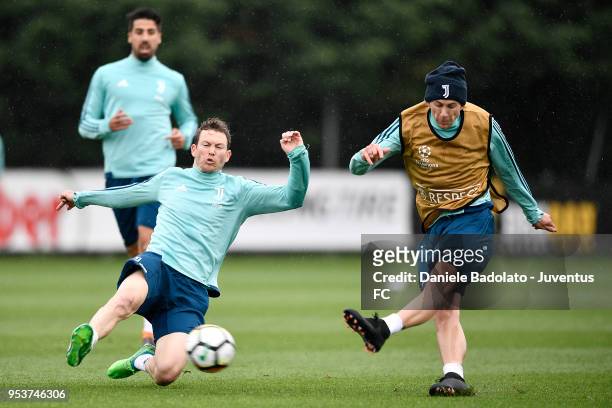 Stephan Lichtsteiner and Federico Bernardeschi during the Juventus training session at Juventus Center Vinovo on May 2, 2018 in Vinovo, Italy.