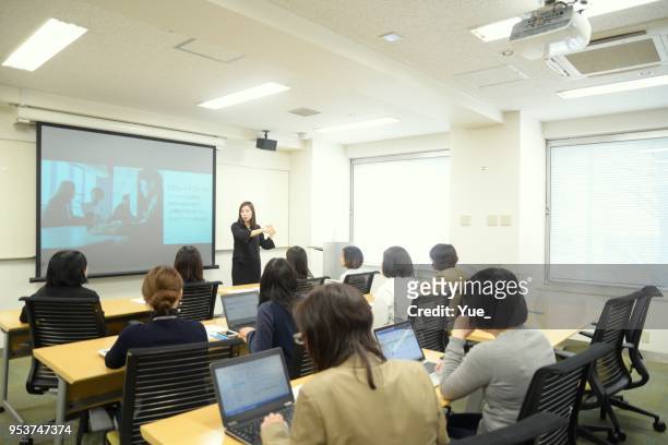 young business woman giving a presentation - japan training session stock pictures, royalty-free photos & images