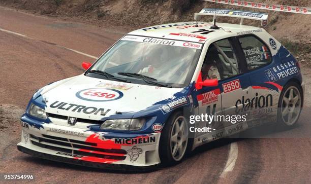 Frenchman Francois Delecour and teammate Daniel Grataloup take their Peugeot around a bend during the final leg of the Rally of Corsica 06 May....