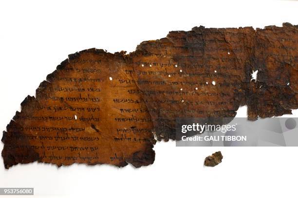 Picture taken on May 2, 2018 at the Israel Antiquities Authority's Dead Sea scrolls conservation laboratory in Jerusalem shows a large fragment of a...