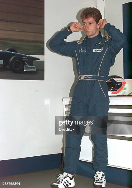 Italian Prost-Mugen-Honda driver Jarno Trulli closes his ears, 28 June in the pits of the Magny-Cours racetrack, during the second free practice...