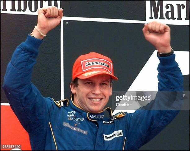 Jubilant french driver Olivier Panis of Prost-Mugen-Honda team raises his arms after he finished second of the F1 Spanish Grand Prix in Montmelo 25...