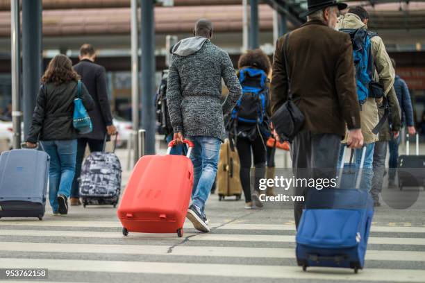 passengers with suitcasses - busy airport stock pictures, royalty-free photos & images